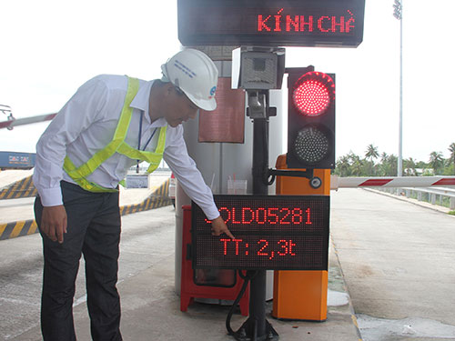 Place the weighing stations at toll booths to strangle overloaded vehicles